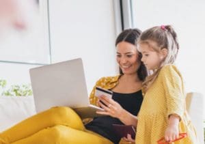 mother and daughter using laptop computer