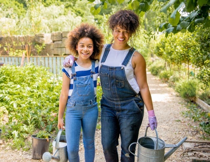 mother and daughter watering the garden
