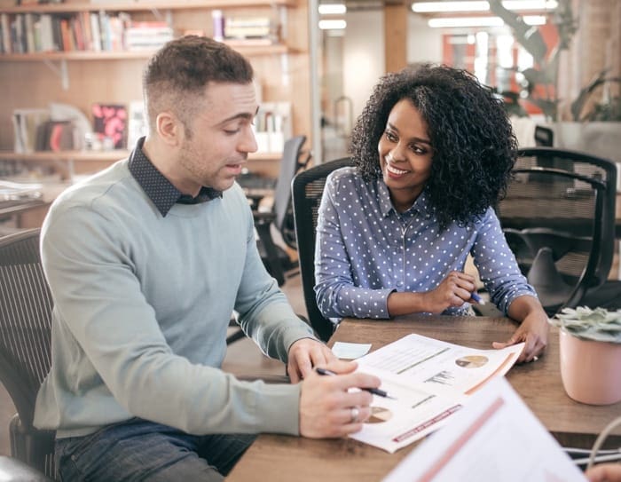 man and woman reviewing report