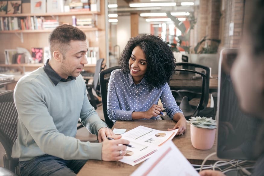 man and woman reviewing report