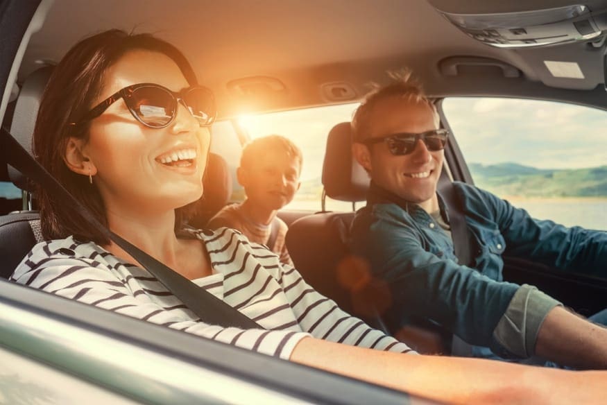 young family driving in car