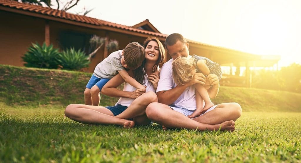 young family outside their home