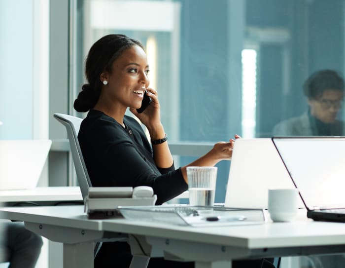 A woman on a phone call in a business office.