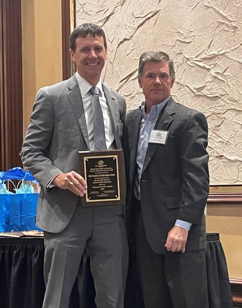 Photo of First Farmers and Merchants Bank representatives receiving the C.A.R.E. award from the Tennessee Area Council of Boys & Girls Clubs